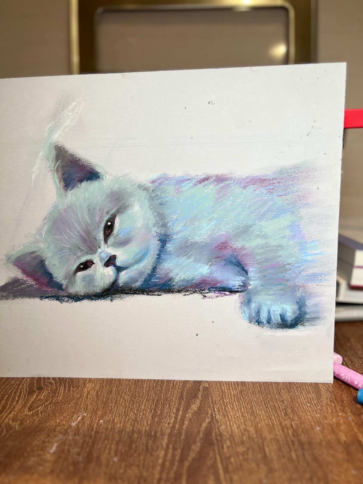 Cool-toned pastel study of a resting kitten.